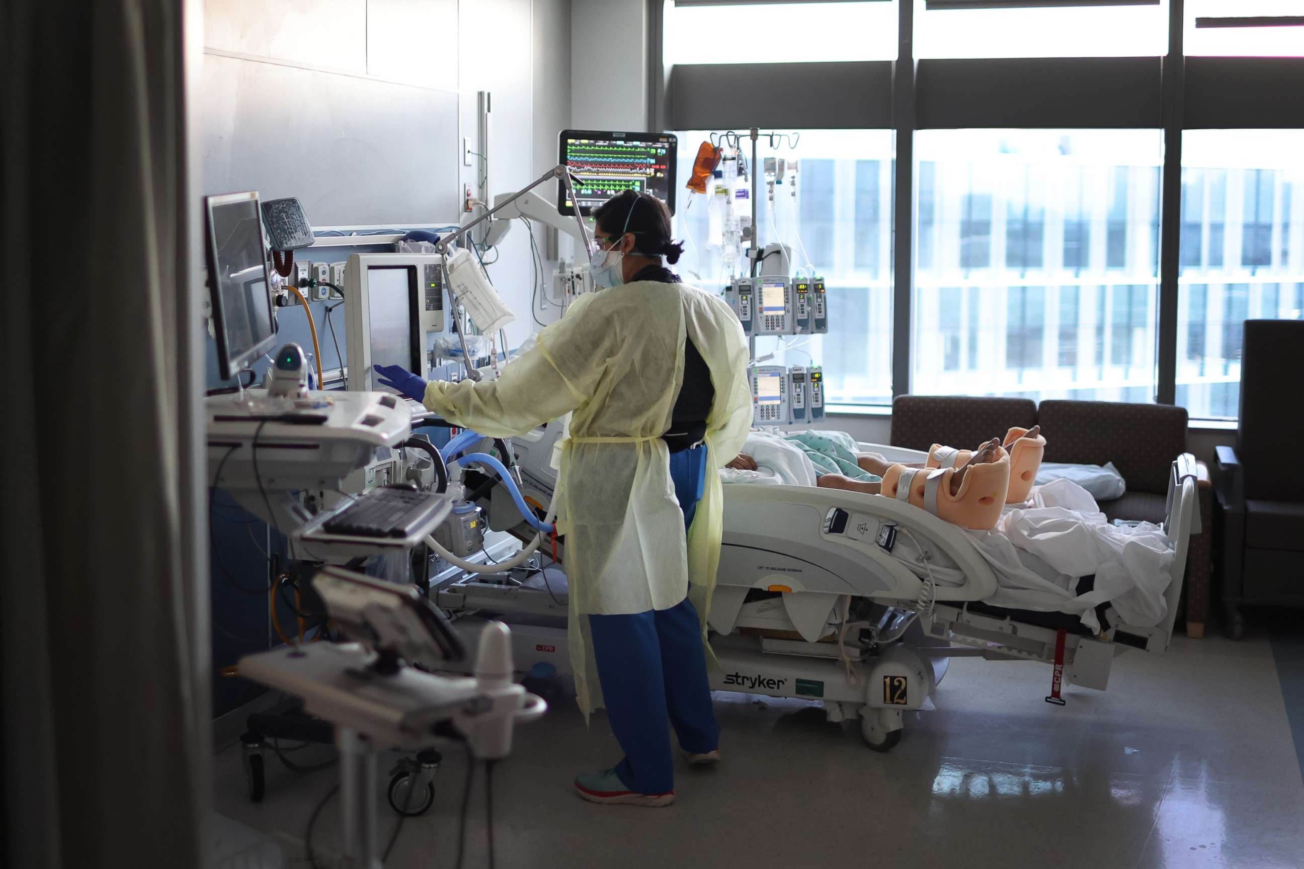 PHOTO: Respiratory Therapist Nirali Patel works with a COVID-19 patient in the ICU at Rush University Medial Center on January 31, 2022 in Chicago, Illinois.