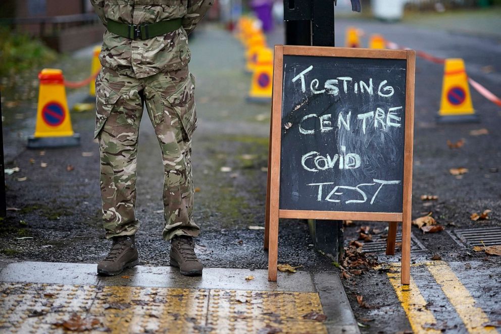 PHOTO: A soldier from the 1st battalion Coldstream Guards greets members of the public at a coronavirus testing center on Nov. 11, 2020 in Liverpool, England. More than 23,000 people had been tested for covid-19 in the city's mass testing trial.