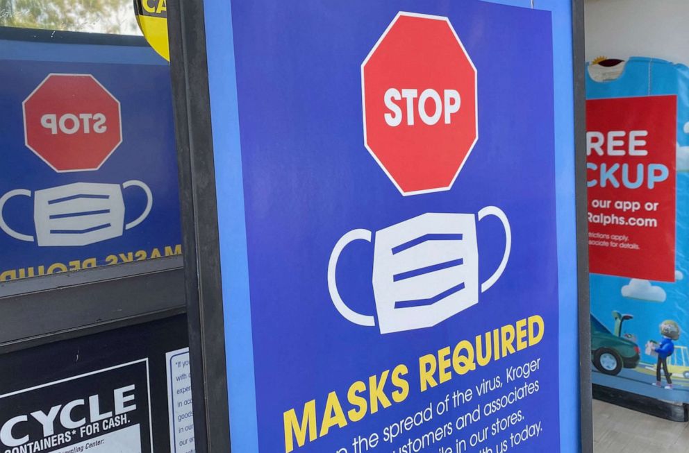 PHOTO: A sign posted at the entrance of a store tells people not to enter without a mask in Los Angeles, July 23, 2021.