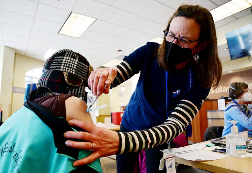 PHOTO: Medical Reserve Corp volunteer Ann Tranvik, a registered nurse from Robbinsdale, administers a COVID-19 vaccination during a clinic at the Consulate of Mexico in St. Paul, Minn., Jan. 12, 2022.
