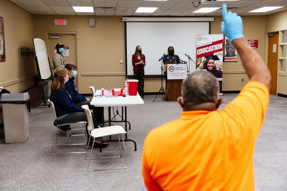 PHOTO: Luther Brown, founder of Little Hands, Little Feet, a gun safety advocacy organization, raises his hand to ask a question about the Moderna vaccine at the Louisville Urban League in Louisville, Ky., Jan. 20, 2021