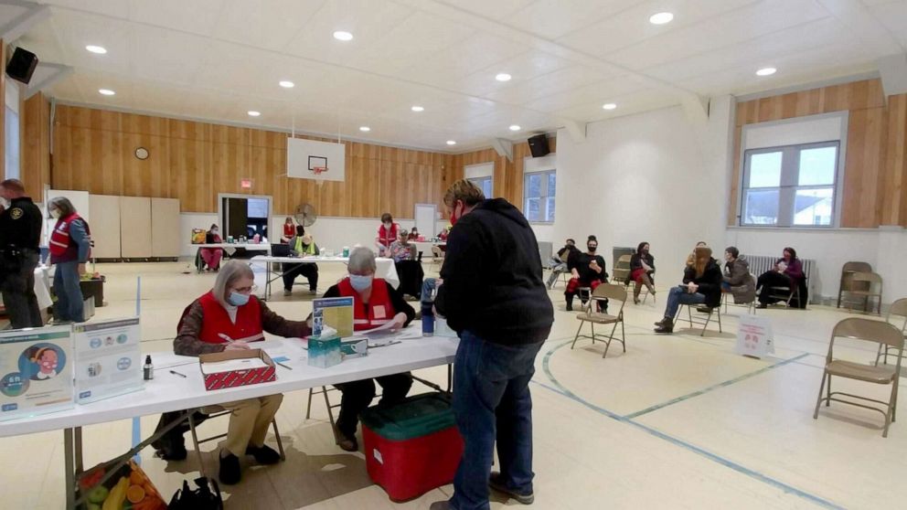 PHOTO: Residents receive COVID-19 shots at Wells Community Hall vaccination site, a former school gym, in Hamilton, County, New York. As of mid-May, Hamilton had among the highest vaccination rates in the country.