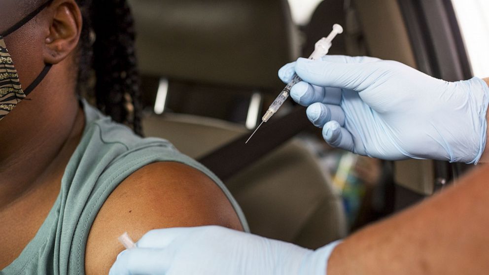 PHOTO: A healthcare worker administers a Covid-19 vaccine at the Austin Regional Clinic drive-thru vaccination and testing site in Austin, Texas, , Aug. 5, 2021.