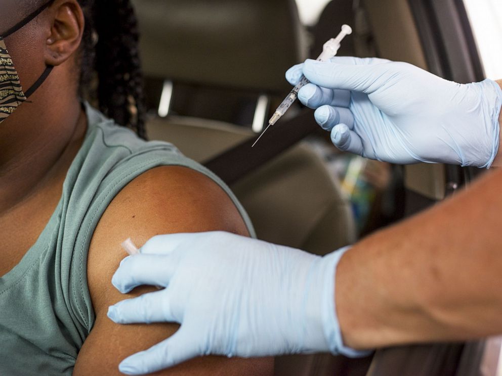 PHOTO: A healthcare worker administers a Covid-19 vaccine at the Austin Regional Clinic drive-thru vaccination and testing site in Austin, Texas, , Aug. 5, 2021.