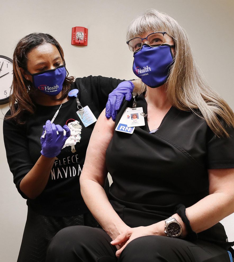 PHOTO: Janet Bennett, right, a registered nurse, receives her COVID-19 vaccine from clinical pharmacist Erica Jasper at UF Health Leesburg Hospital Urgent Care on Dec. 17, 2020, in Leesburg, Fla.