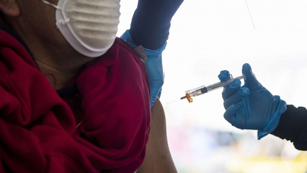 PHOTO: A healthcare worker administers a dose of the Moderna Covid-19 vaccine to a farmworker at a vaccination clinic organized by the Santa Clara County Public Health Department at Christopher Ranch in Gilroy, Calif., March 4, 2021.