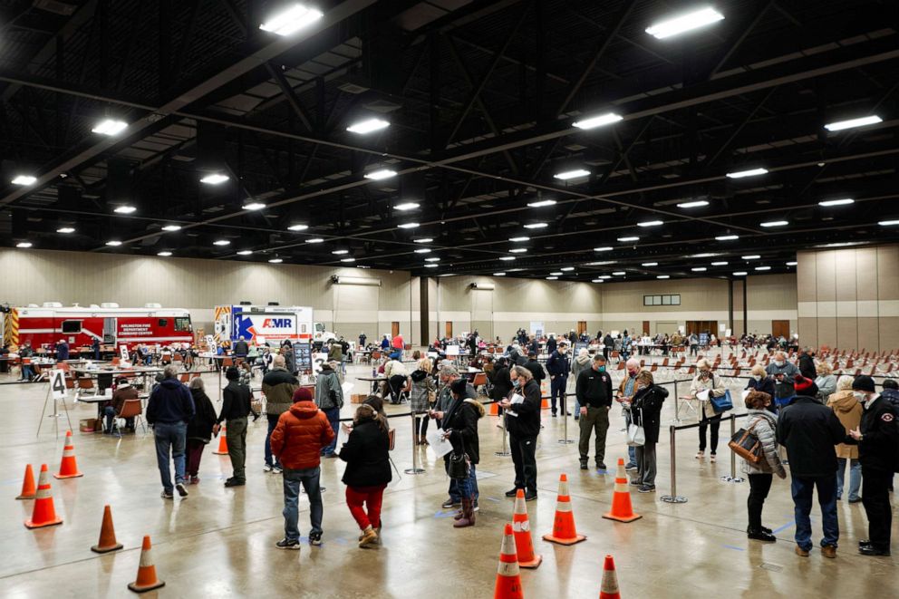 PHOTO: People wait in line to be inoculated against COVID-19 at a vaccination site at the Esports Stadium Arlington & Expo Center in Arlington, Texas, Feb. 12, 2021. 