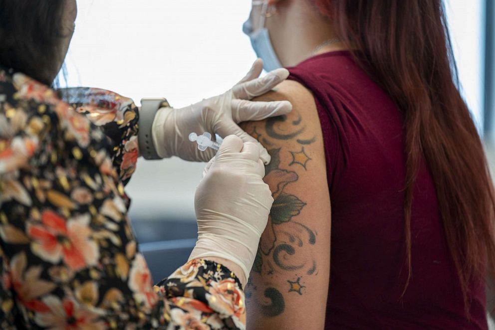 PHOTO: In this March 5, 2021, file photo, a Graves Drug pharmacist administers a dose of the Covid-19 vaccine to a worker at the Creekstone Farms Premium Beef LLC processing plant in Arkansas City, Kansas.