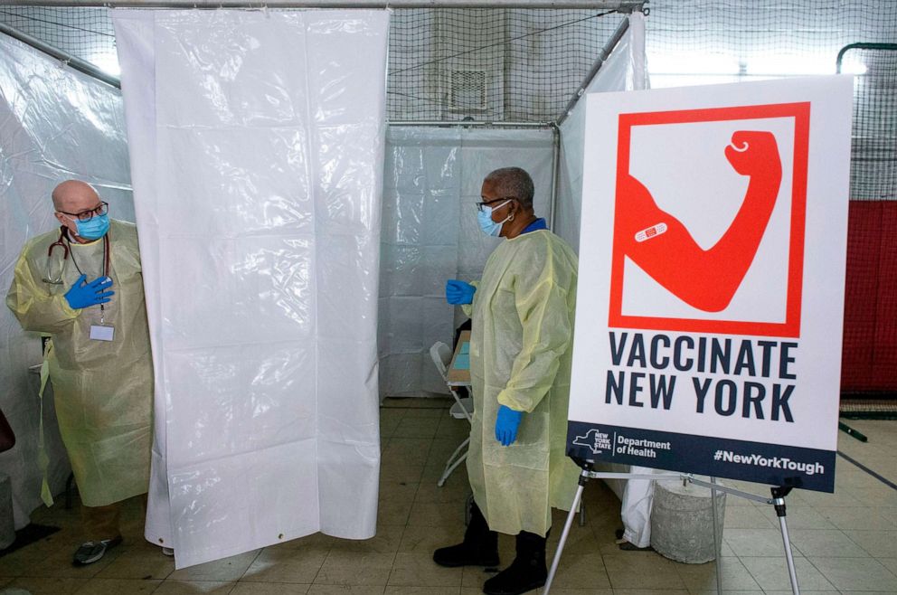 PHOTO:Health workers wait for patients to administer Pfizer Covid-19 vaccines at the opening of a new vaccination site at Corsi Houses in the Harlem area of New York, Jan. 15, 2021. 