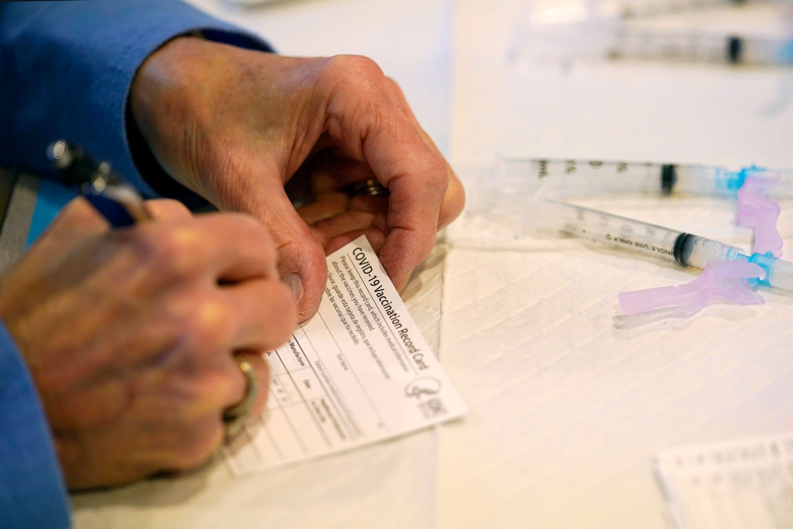 PHOTO: Pat Moore, with the Chester County, Pa., Health Department, fills out a vaccination record card before administering the Moderna COVID-19 vaccine at the Chester County Government Services Center, Dec. 29, 2020, in West Chester, Pa.