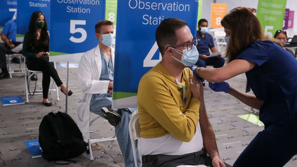 PHOTO: In this Dec. 16, 2020, file photo, an ICU doctor receives the COVID-19 vaccine from an RN at the AdventHealth Tampa distribution tent, in Tampa.
