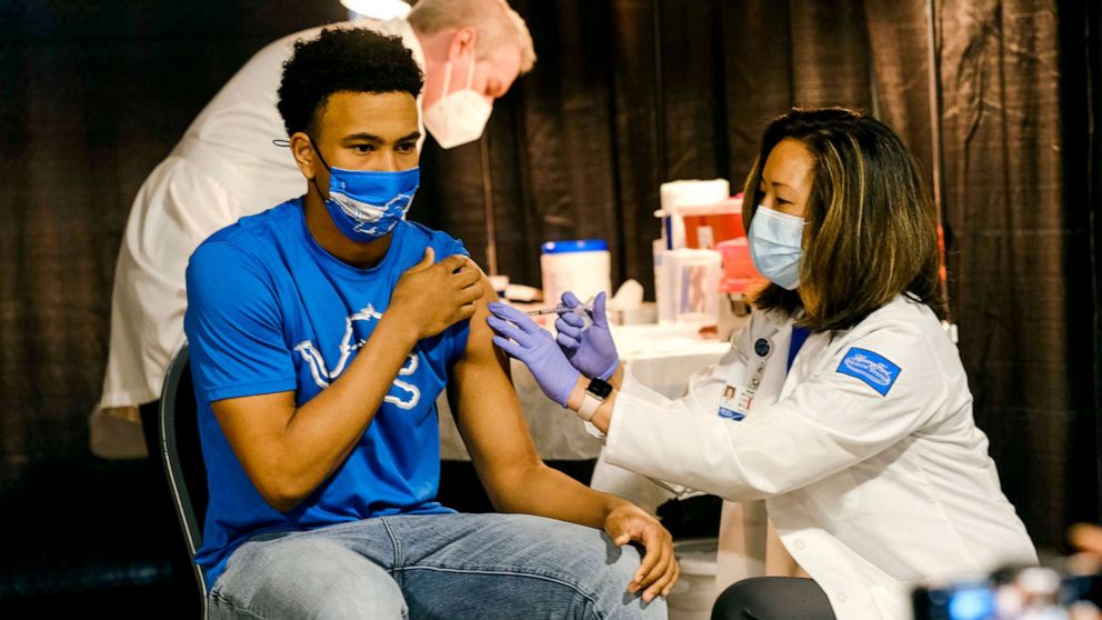 PHOTO: A teenager receives a dose of the Pfizer Covid vaccine at Ford Field, during an event to promote and encourage Michigan residents to go and get their vaccines, April 6, 2021, in Detroit.