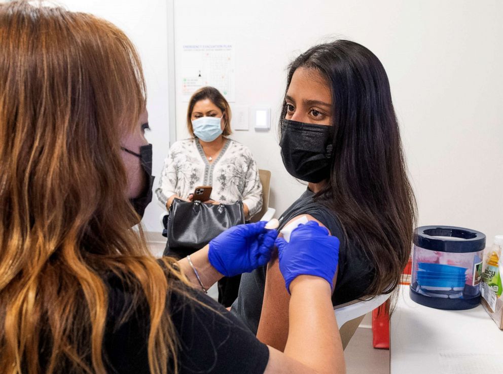 PHOTO: A teenager gets instructions after getting her Pfizer-BioNTech COVID-19 vaccine from an RN at UCI Health Family Health Center in Anaheim, CA, April 28, 2021 as her mom watches.