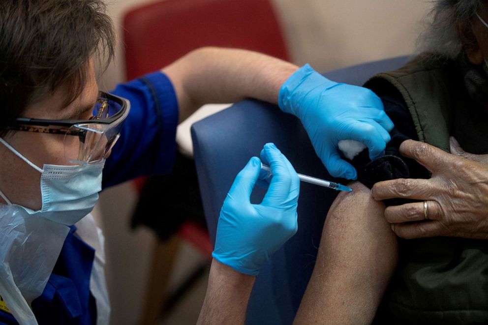 FILE PHOTO: A man receives the first of two Pfizer/BioNTech COVID-19 vaccine jabs, at Guy's Hospital, at the start of the largest ever immunisation programme in the British history, in London, Britain December 8, 2020.