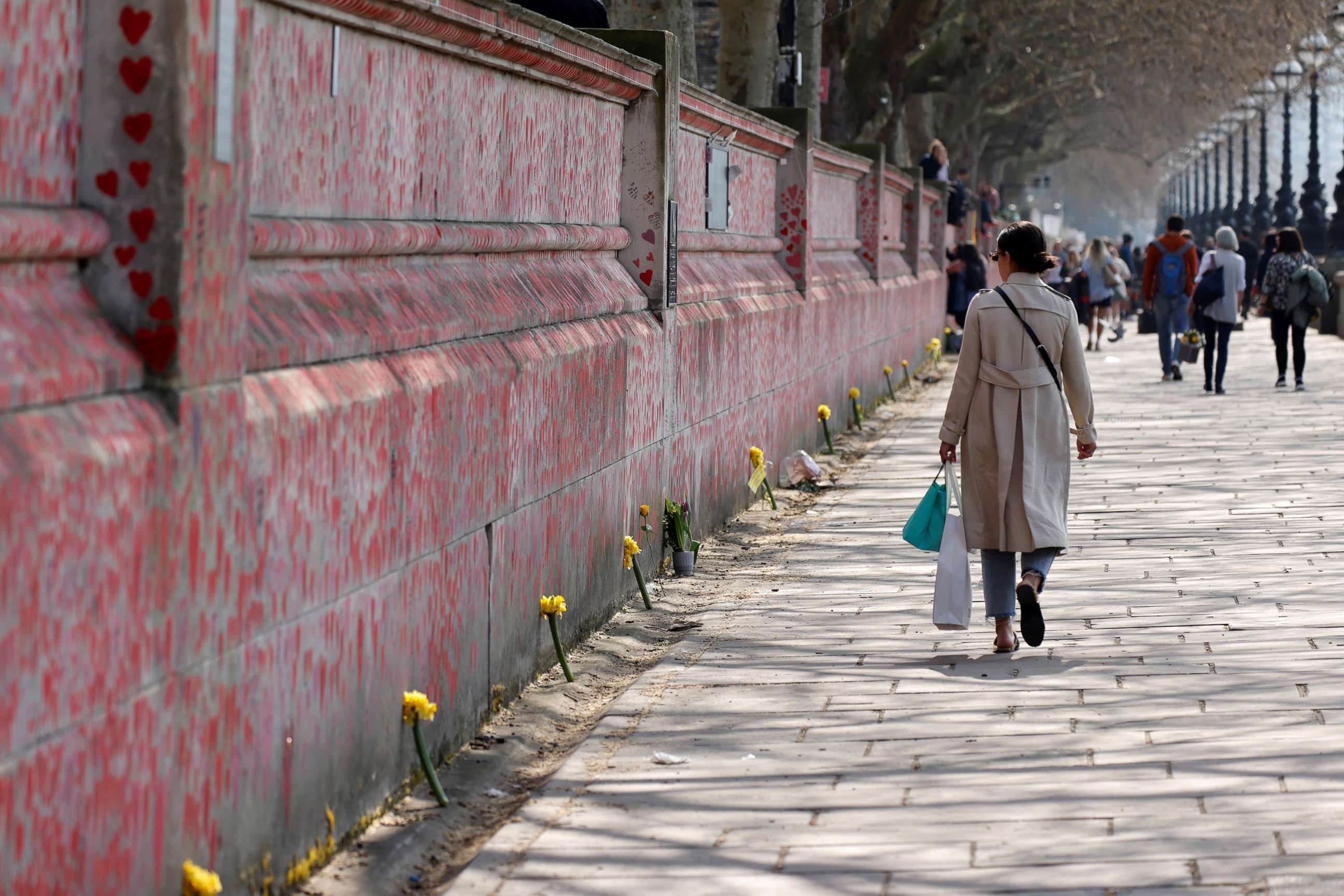 PHOTO: People walk past the National Covid Memorial Wall in London on March 23, 2022.