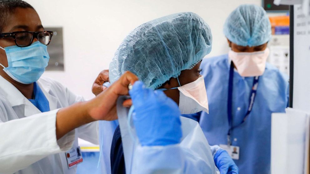 PHOTO: Medical personnel adjust their personal protective equipment while working in the emergency department at NYC Health + Hospitals Metropolitan, May 27, 2020, in New York.