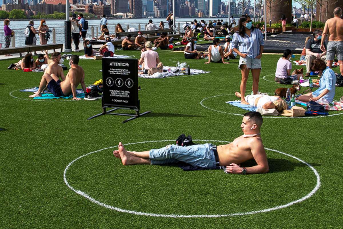 PHOTO: People try to keep social distance as they enjoy a warm afternoon at Domino Park in Brooklyn, New York, May 16, 2020.