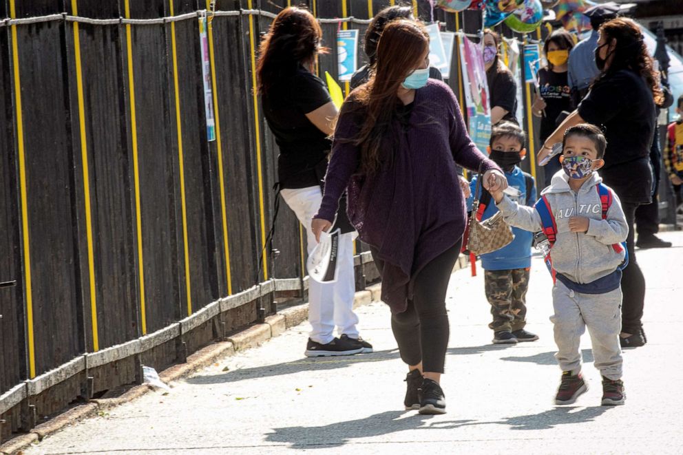 PHOTO: Children are greeted on their first day of pre-school, as New York City pre-school students began in-person school following the outbreak of the coronavirus disease in the Queens borough of New York, Sept. 21, 2020. 