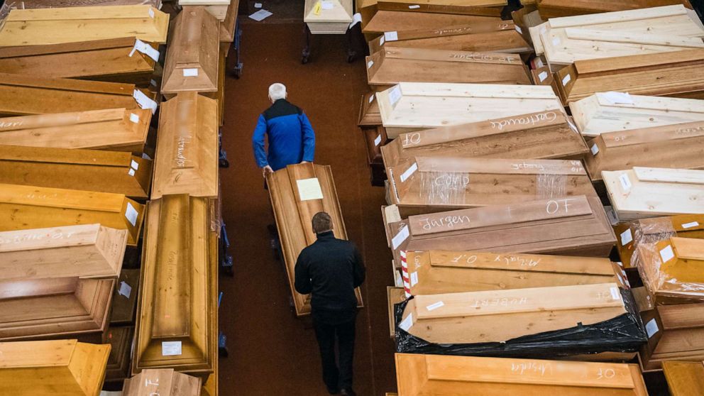 PHOTO: Employees store coffins, some marked with "infection risk" as others have "corona" scrawled in chalk, in the morning hall of the crematorium in Meissen, Germany, Jan. 13, 2021.