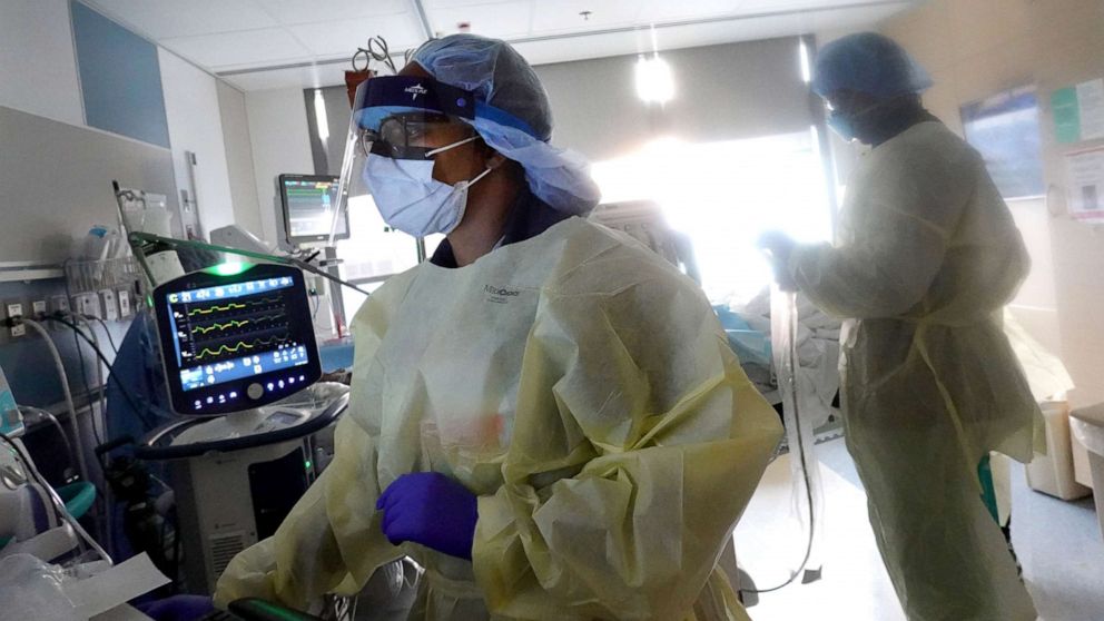 PHOTO: A respiratory therapist helps to treat a COVID-19 patient in the ICU at Rush University Medial Center on Jan. 31, 2022 in Chicago.