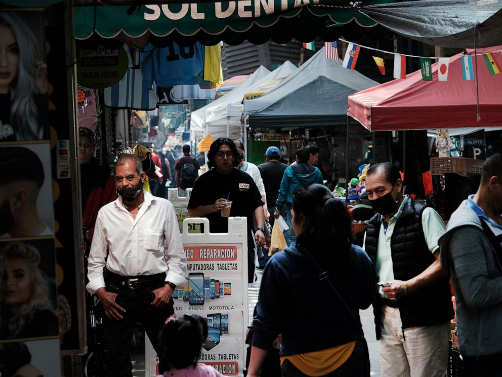 PHOTO: People walk along Roosevelt Avenue on May 11, 2023 in Queens, New York City.