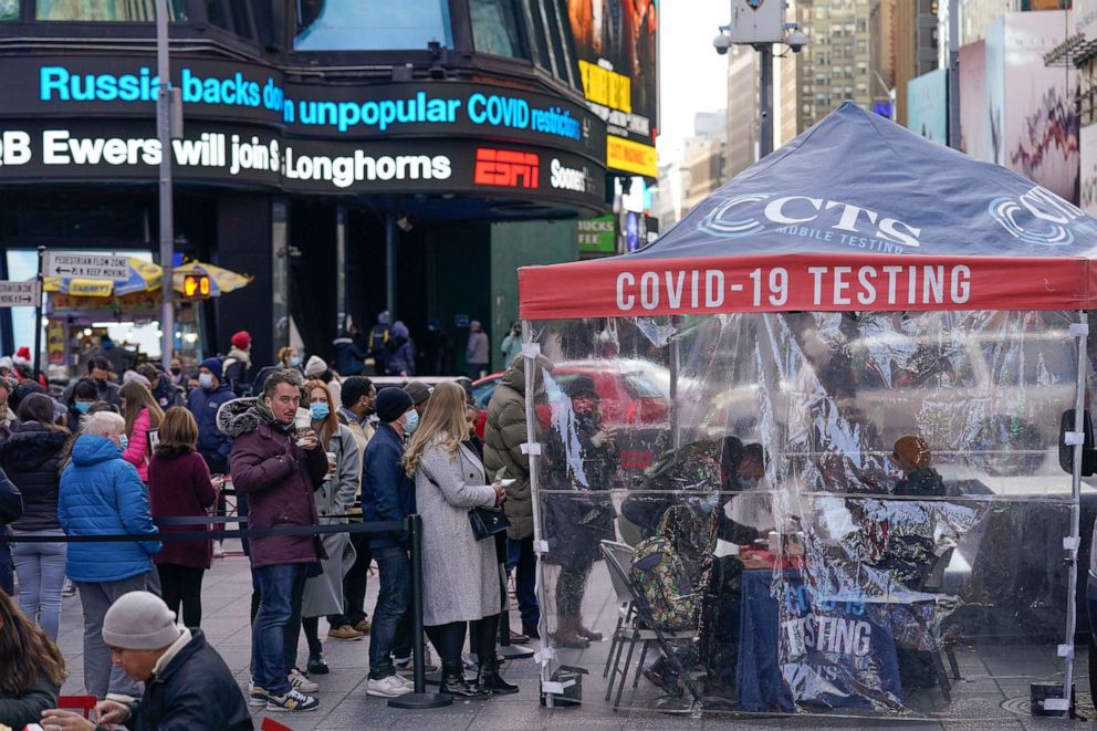 PHOTO: People wait in line at a COVID-19 testing site in Times Square, New York, Dec. 13, 2021.