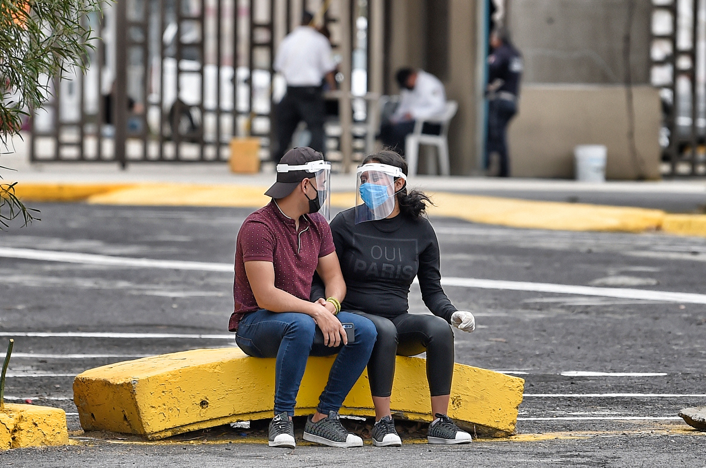 PHOTO: A couple waits for their relatives at the Municipal Pantheon of Ciudad Nezahualcoyotl, in State of Mexico on June 3, 2020.