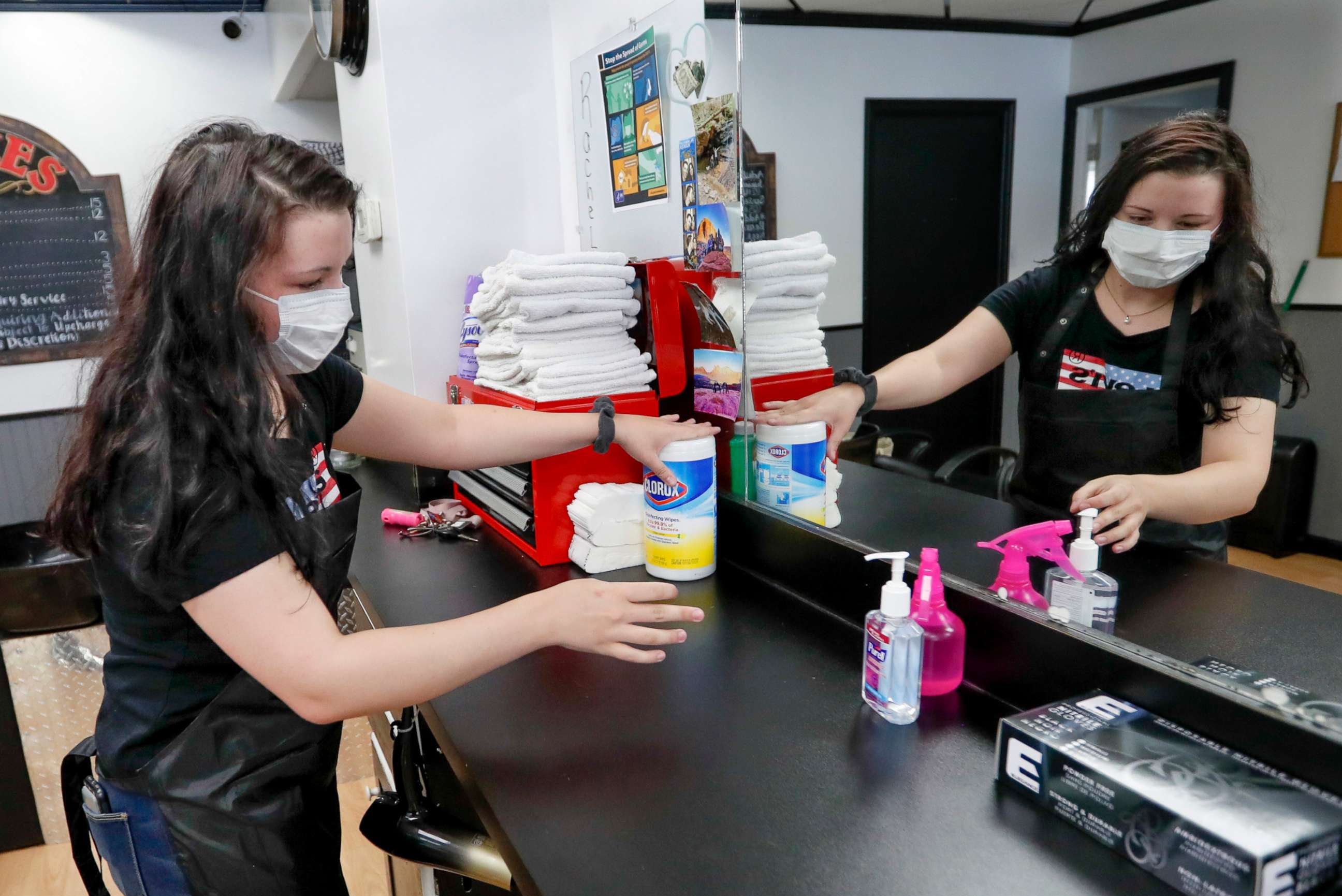 PHOTO: Stylist Kayla Addink arranges items in her workspace Thursday, June 4, 2020, as she prepares for her first day back on the job at the West View Barber Shop when most of southwest Pennsylvania loosens COVID-19 restrictions on Friday.