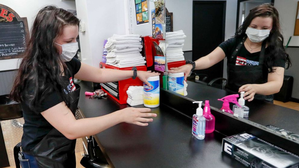 PHOTO: Stylist Kayla Addink arranges items in her workspace Thursday, June 4, 2020, as she prepares for her first day back on the job at the West View Barber Shop when most of southwest Pennsylvania loosens COVID-19 restrictions on Friday.