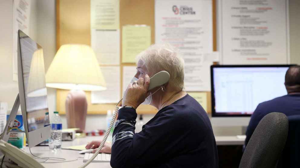 PHOTO: Volunteer Debbie Nelson answers the phone at the Memphis Crisis Center, which has been fielding crisis calls in Shelby County for more than 50 years, at the center in Memphis, Tenn., April 4, 2022.