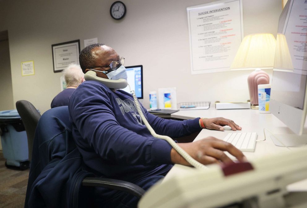 PHOTO: Volunteer Howard Mell answers the phone at the Memphis Crisis Center, which has been responding to crisis calls in Shelby County for more than 50 years in Memphis, April 4, 2022.