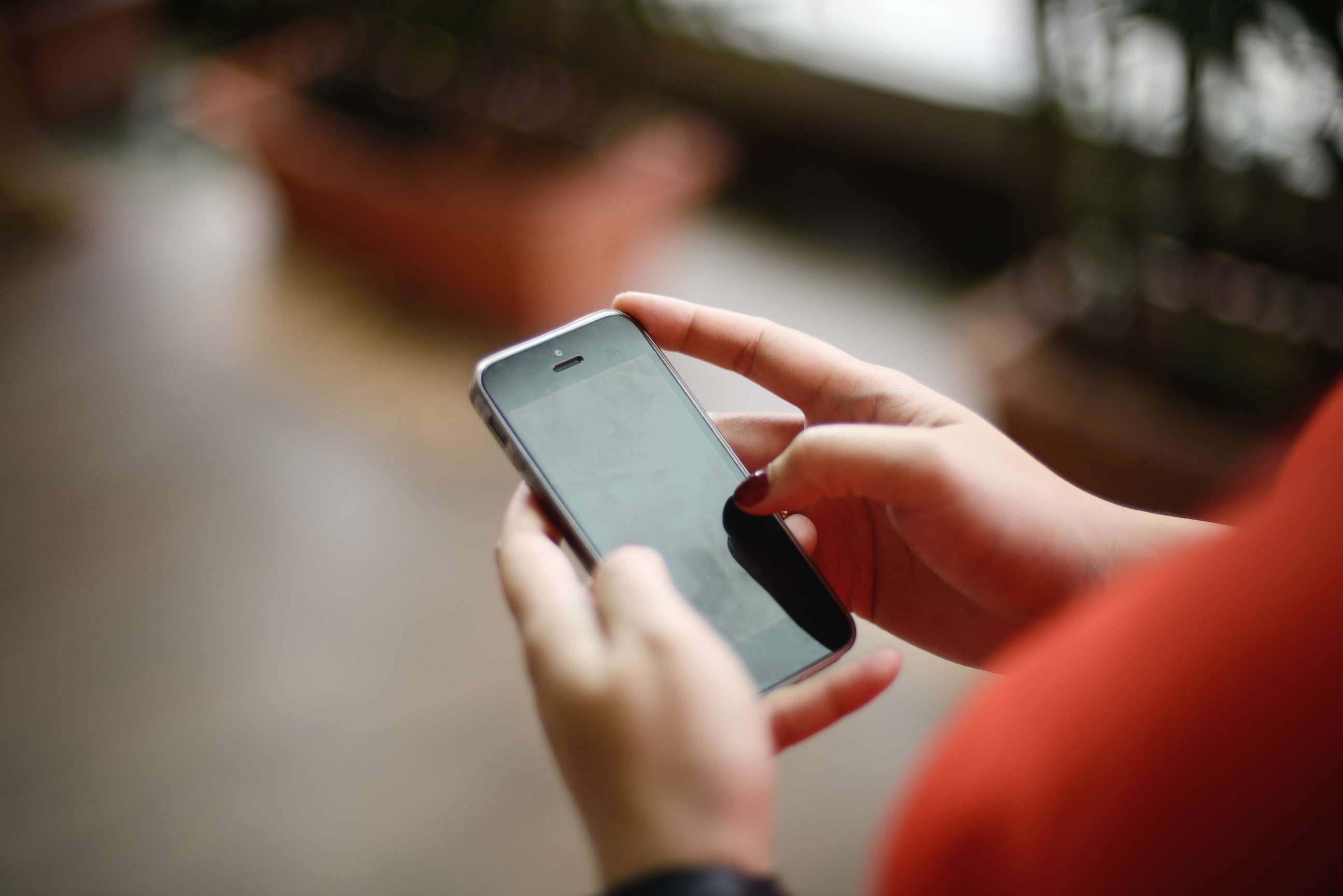 PHOTO: A woman uses a phone in this undated stock photo.