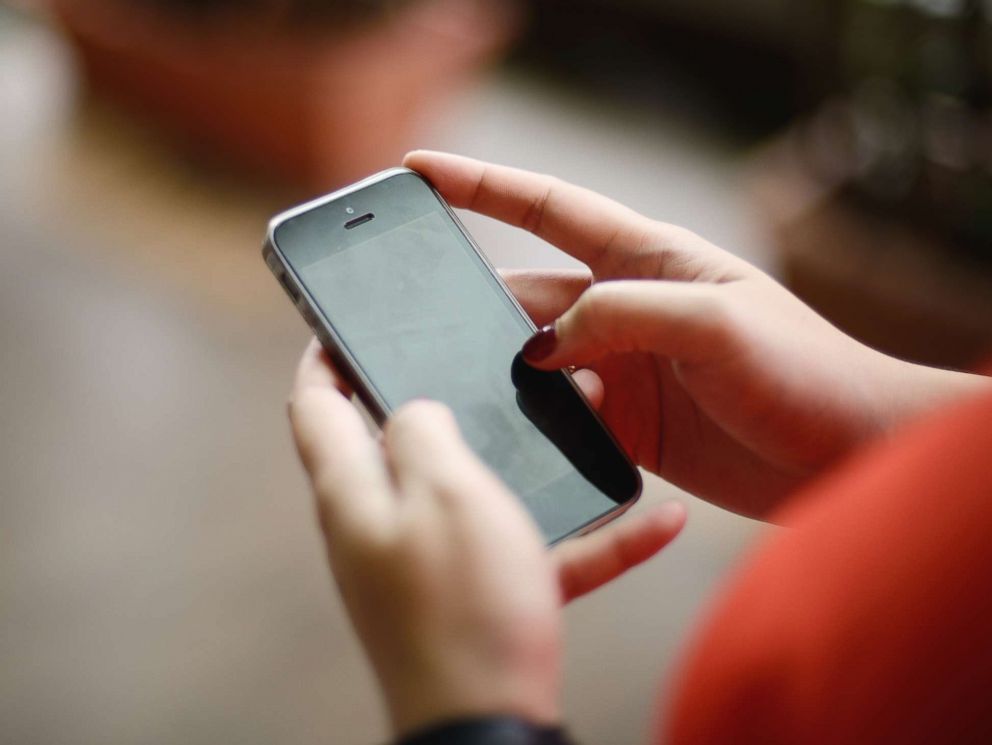 PHOTO: A woman uses a phone in this undated stock photo.