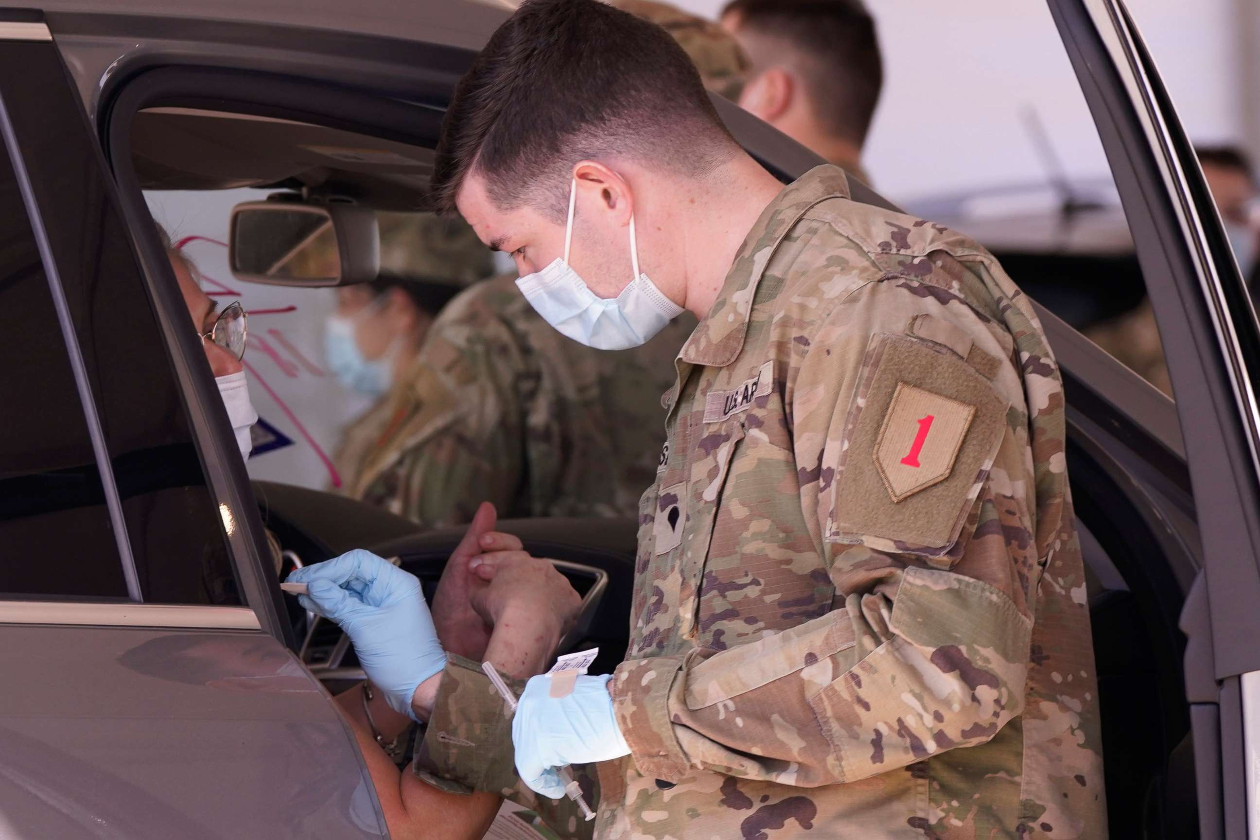 PHOTO: A soldier in a face mask prepares to administer a dose of the Pfizer's COVID-19 vaccine, March 3, 2021, in Dallas.