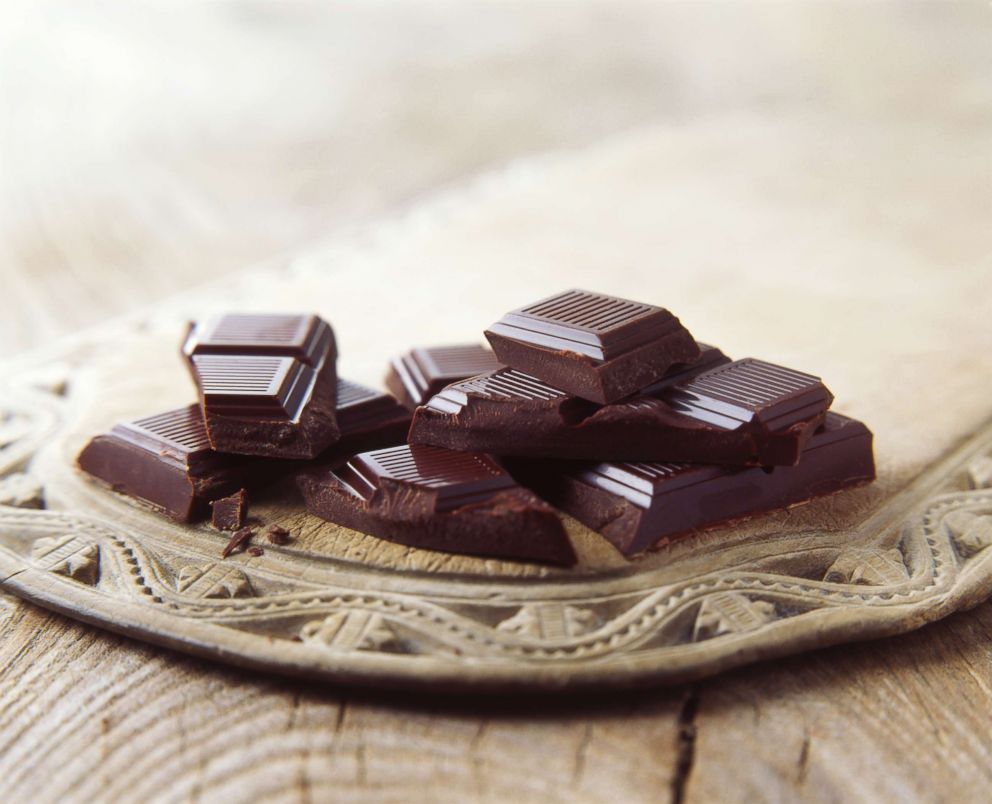 PHOTO: Dark chocolate is pictured broken on vintage wooden board in this undated stock photo.