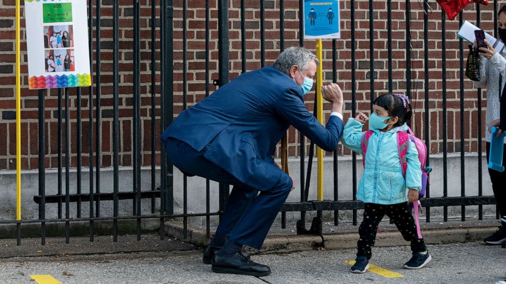 PHOTO: Mayor Bill de Blasio wearing a face mask, greets a student at Mosaic Pre-K Center in Queens, Sept. 21, 2020, as some students return to classrooms in the wake of the coronavirus.