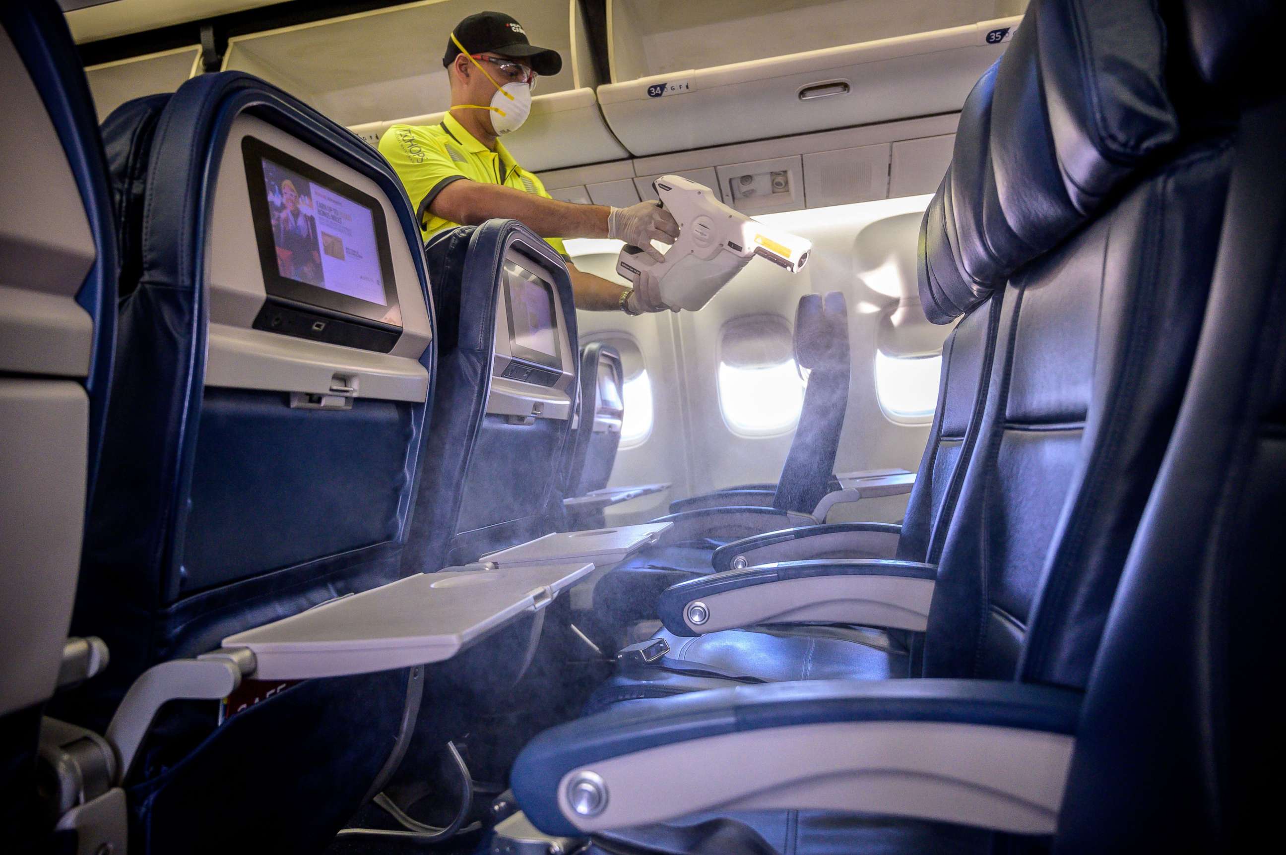 PHOTO: Members of Delta's line maintenance crew disinfect the surfaces of the cabin including tray tables, seat backs and in-flight entertainment screens in a Boeing 757 in Atlanta, Ga., on Friday, March 6, 2020.