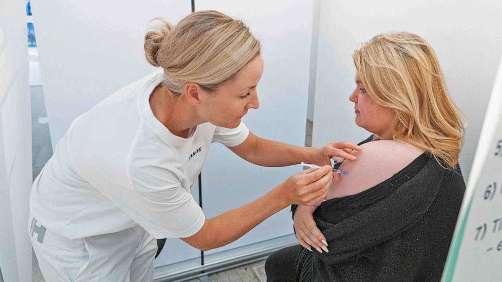 PHOTO: A medical personnel administers a Covid-19 vaccine to a woman at a pop-up vaccination center in a Bilka supermarket in Ishoej, Denmark, on a vaccination day, on Sept. 11, 2021. 