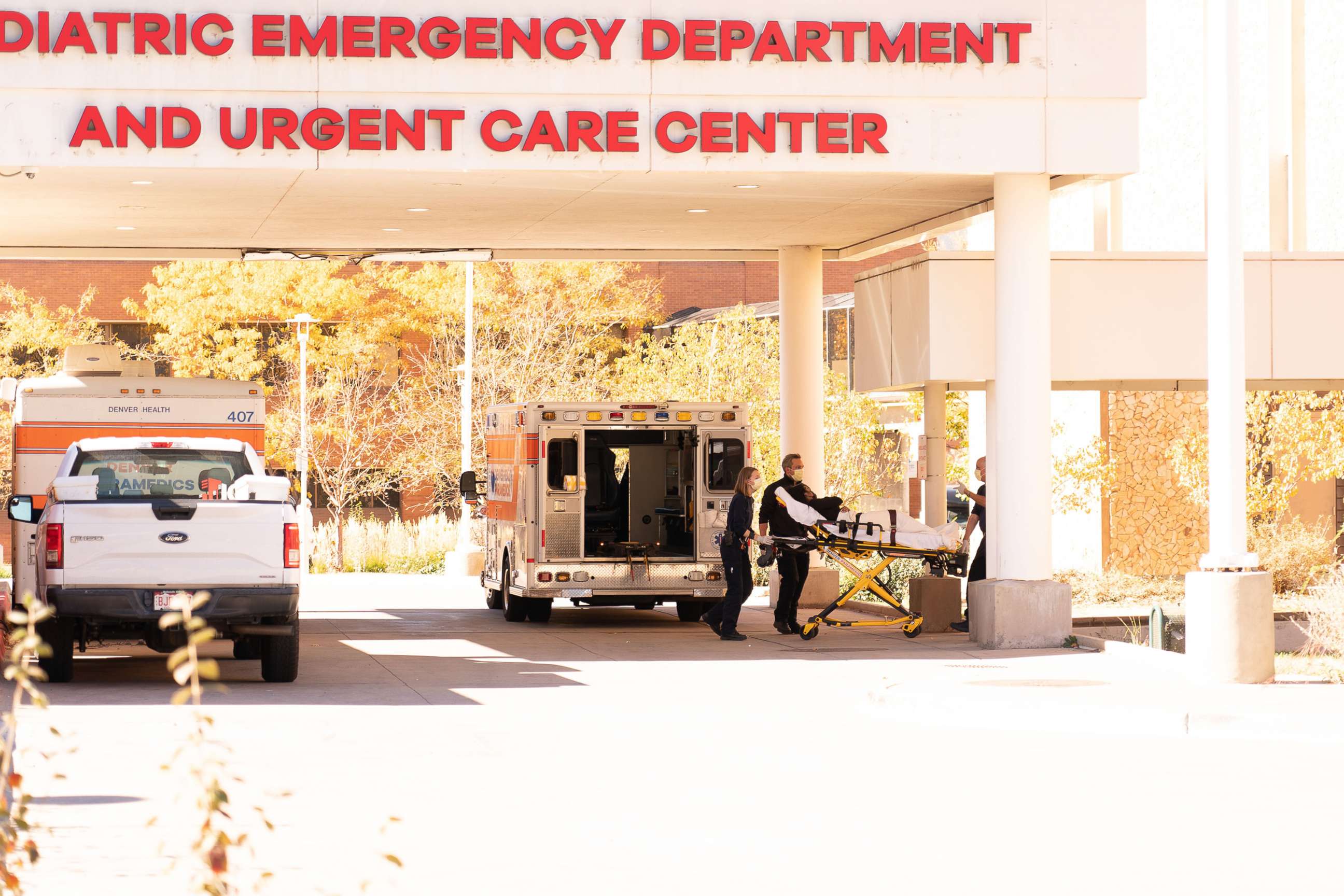PHOTO: An ambulance crew wheels a person on a stretcher outside the emergency entrance of the Denver Health Hospital Complex in Denver, Nov. 4, 2021.