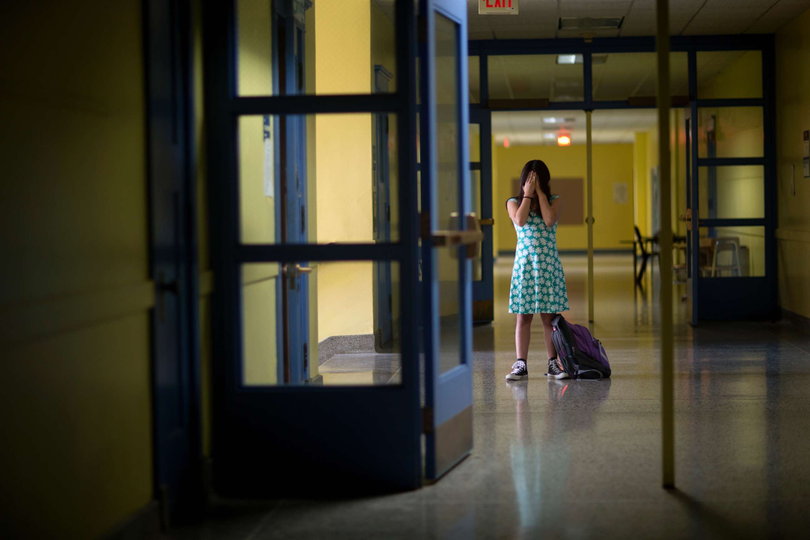 PHOTO: An undated stock photo of a girl in an empty school hallway.