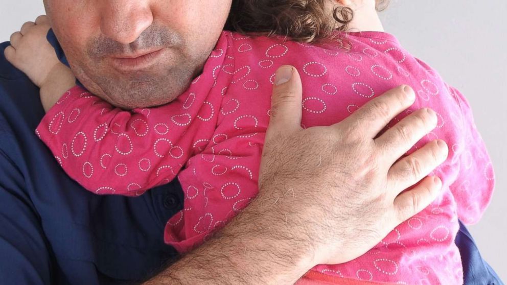 PHOTO: A father holds his child in an undated stock photo. 