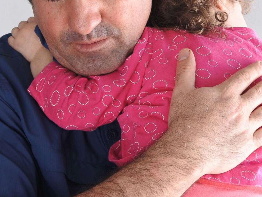 PHOTO: A father holds his child in an undated stock photo.