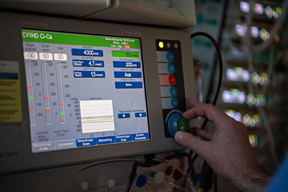 PHOTO: A doctor operates a dialysis machine in an intensive care unit.
