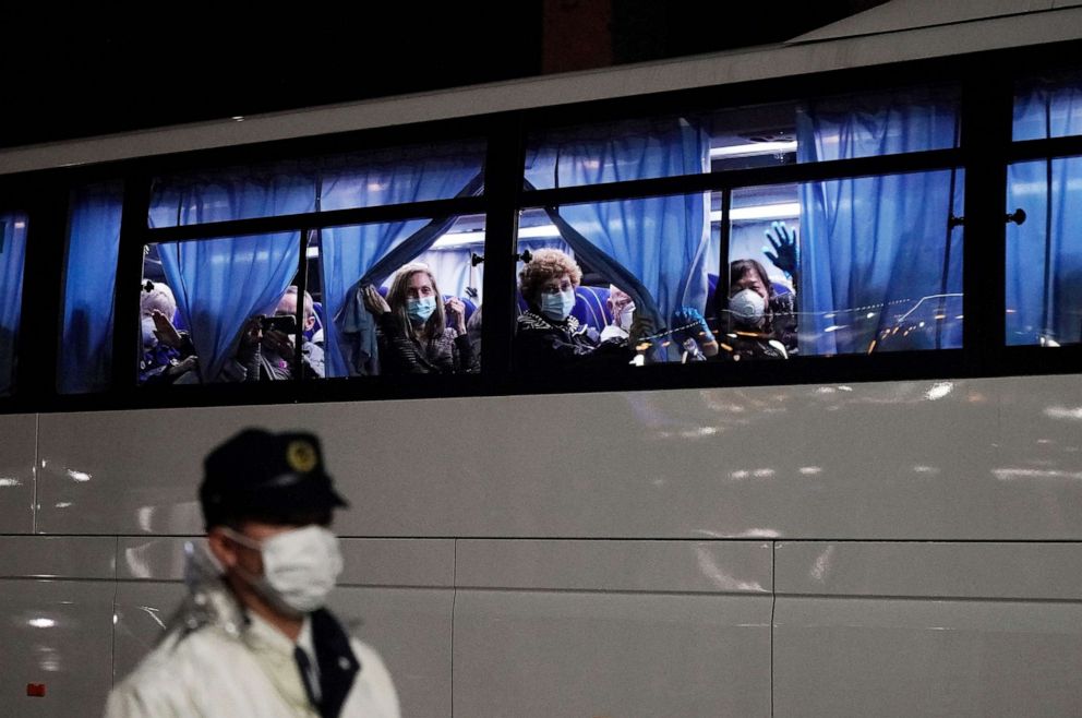 PHOTO: U.S. citizens wave from a bus as they leave the Diamond Princess cruise ship docked at Daikoku Pier Cruise Terminal for repatriation in Yokohama, Tokyo, Japan, Feb. 17, 2020.