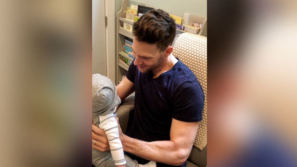 PHOTO: Trainer and nutrition expert Joey Thurman holds his son in his nursery.