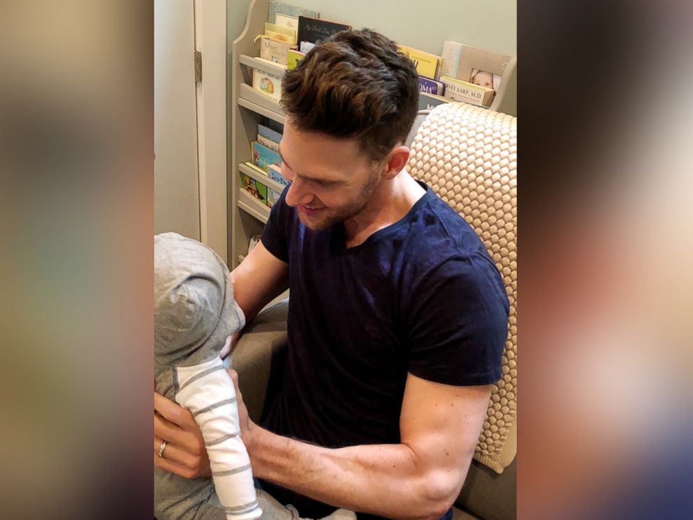 PHOTO: Trainer and nutrition expert Joey Thurman holds his son in his nursery.