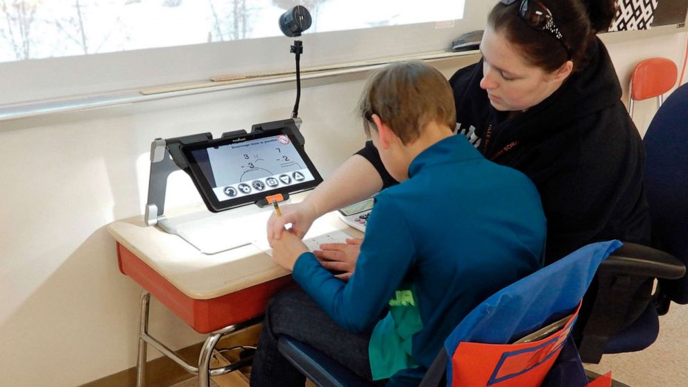 PHOTO: A classroom aide helps a student using electronic magnifier equipment in Wellsville, New York, Jan. 30, 2020.  