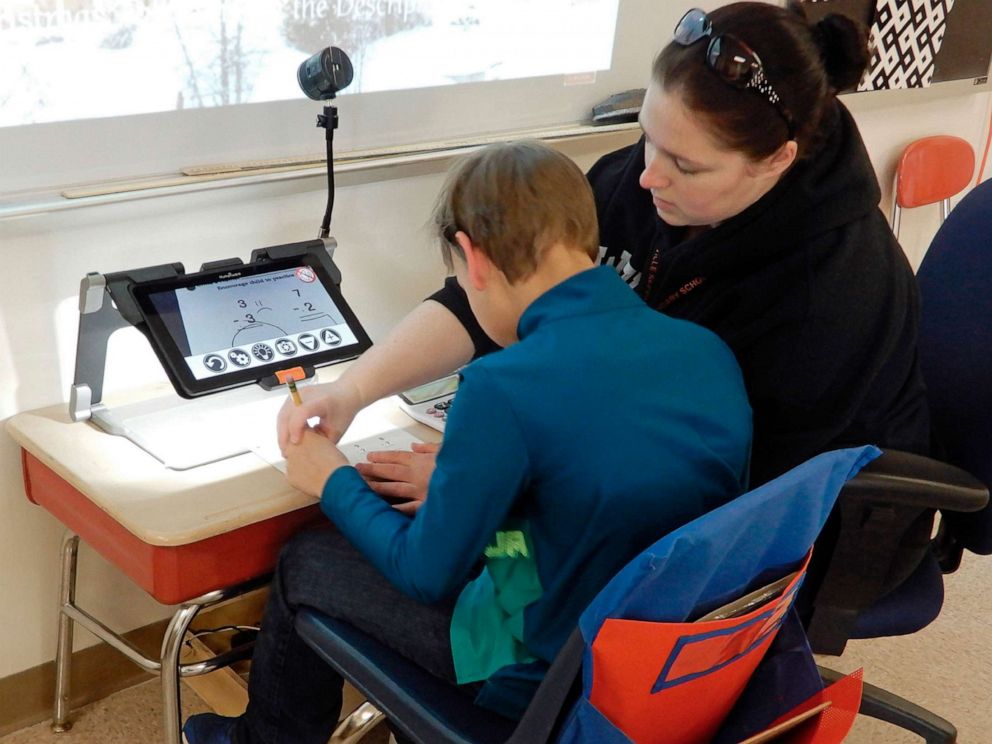 PHOTO: A classroom aide helps a student using electronic magnifier equipment in Wellsville, New York, Jan. 30, 2020.  