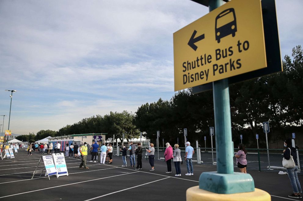 PHOTO: People wait in line to receive the COVID-19 vaccine at a mass vaccination site in a parking lot for Disneyland Resort on Jan. 13, 2021, in Anaheim, Calif