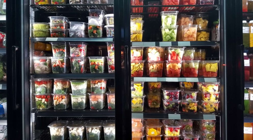 PHOTO: Healthy cut fruit and vegetables on display in store window of a grocery store in the East Village, New York, N.Y.